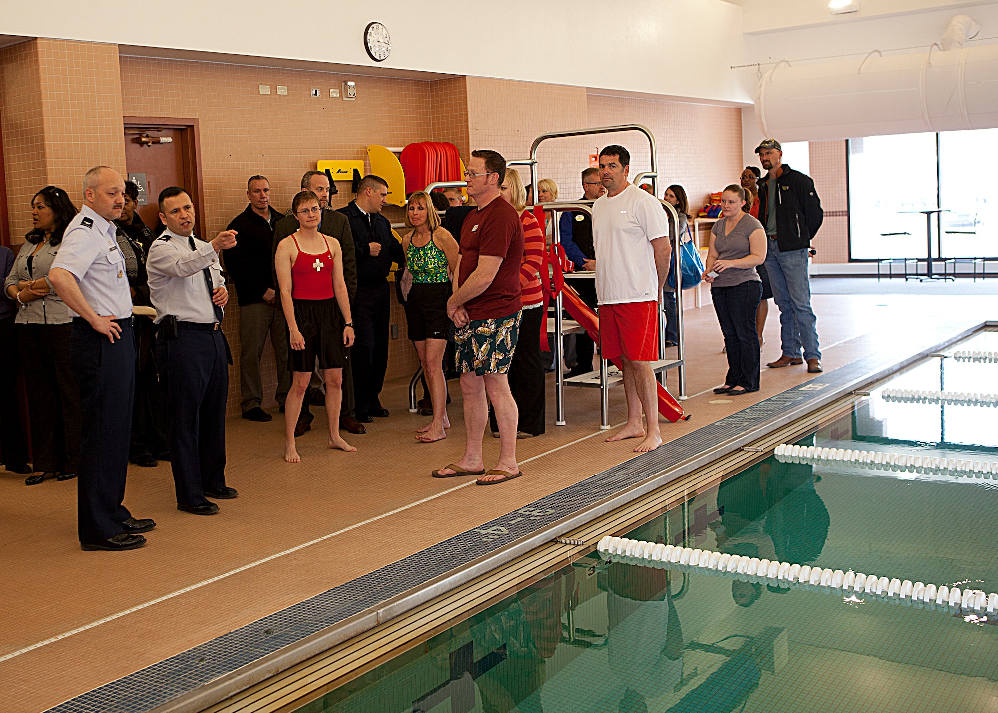 Col. Christopher Coffelt, 90th Missile Wing commander; Maj. Ricardo Garcia, 90th Force Support Squadron commander, and other guests look over the Warren Aquatic Center at its grand re-opening April 1. (U.S. Air Force photo by Matt Bilden)