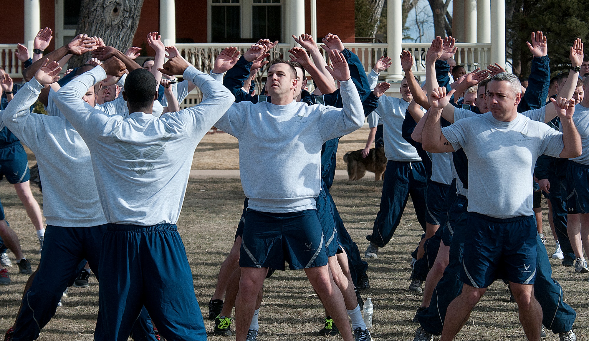 Members of the 90th Security Group do jumping jacks March 29 as a warm-up prior to their “pride run” on F. E. Warren Air Force Base. (U.S. Air Force photo by R.J. Oriez)