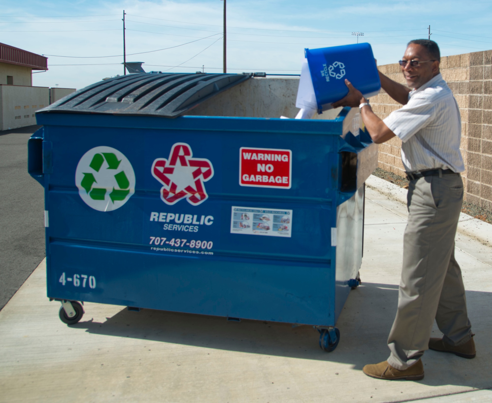 Arvey Andrews, 60th Civil Engineer Squadron facility manager for building 570, recycles old paper into the new, blue recycling bin April 3 on Travis Air Force Base, Calif. The blue recycling bins will start being distributed around base. (U.S. Air Force photo/Airman 1st Class Nicole Leidholm)