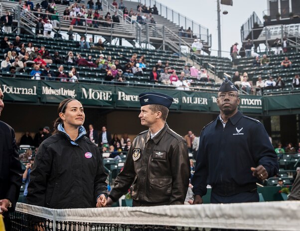 Col. Dennis Dabney (right), 437th Maintenance Group commander, tosses a command coin to open a match April 3, 2013, at the Family Circle Cup Tennis Tournament in Daniel Island, S.C. A five-member honor guard team posted the Colors and base leaders had the honor of conducting the coin toss prior to the match. (U.S. Air Force photo/ Senior Airman Dennis Sloan)