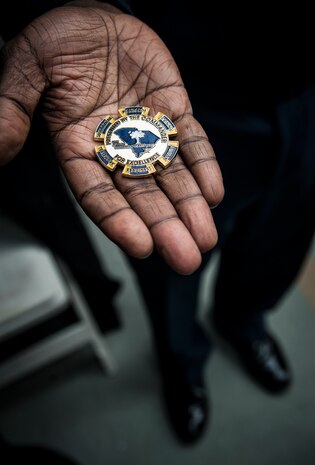 Col. Dennis Dabney, 437th Maintenance Group commander, displays his Group coin before tossing it to open a match April 3, 2013, at the Family Circle Cup Tennis Tournament in Daniel Island, S.C. (U.S. Air Force photo/ Senior Airman Dennis Sloan)