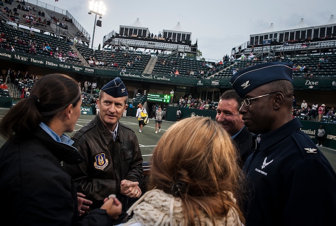 Col. James Fontanella, 315th Airlift Wing commander (left), and Col. Dennis Dabney, 437th Maintenance Group commander, prepare to walk out to center court to toss a command coin to start a match April 3, 2013, at the Family Circle Cup Tennis Tournament in Daniel Island, S.C. (U.S. Air Force photo/ Senior Airman Dennis Sloan)