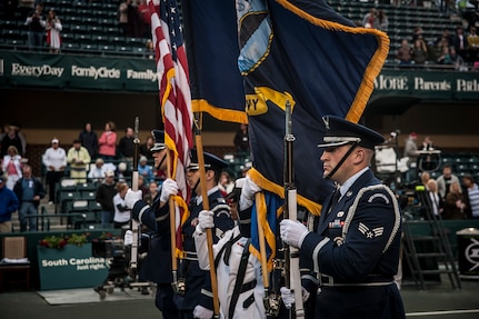 Joint Base Honor Guard members post the Colors April 3, 2013, at the Family Circle Cup Tennis Tournament in Daniel Island, S.C. A five-member honor guard team posted the Colors and base leaders had the honor of conducting the coin toss prior to the match. (U.S. Air Force photo/ Senior Airman Dennis Sloan)