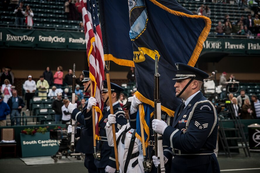 Joint Base Honor Guard members post the Colors April 3, 2013, at the Family Circle Cup Tennis Tournament in Daniel Island, S.C. A five-member honor guard team posted the Colors and base leaders had the honor of conducting the coin toss prior to the match. (U.S. Air Force photo/Senior Airman Dennis Sloan) 

