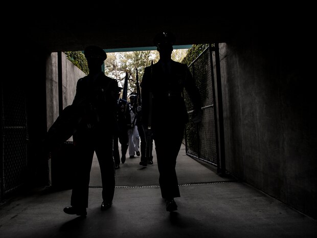 Joint Base Charleston Honor Guard members file into Family Circle Tennis Center before posting the Colors April 3, 2013, at the Family Circle Cup Tennis Tournament in Daniel Island, S.C. A five-member honor guard team posted the Colors and base leaders had the honor of conducting the coin toss prior to the match. (U.S. Air Force photo/ Senior Airman Dennis Sloan)