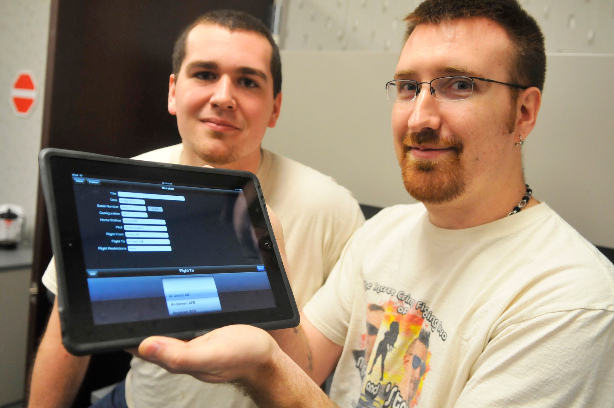 Matthew Thomas (left) and Michael Hope, 578th Software Maintenance Squadron electronics engineers, demonstrate an iPad App. Robins software engineers are developing iPad Apps for cargo aircrews as part of the Electronic Flight Bag initiative. (U. S. Air Force photo by Sue Sapp/Released)
