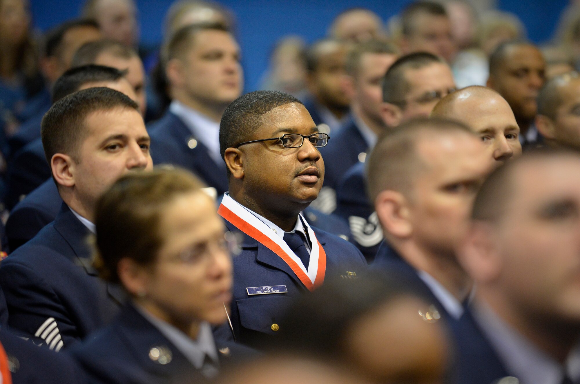 McGHEE TYSON AIR NATIONAL GUARD BASE, Tenn. – Coast Guardsman, Petty Officer 1st Class Jaensen Lewis assigned  to the Puerto Rico Military Entrance Processing Station, San  Juan, watches the graduation ceremony here of  57 Airman Leadership School and 266 Air Force Noncommissioned Officer Academy graduates from the Paul H. Lankford Enlisted Professional Military Education Center. Lewis graduated in the top 10 percent of his NCOA class as a Distinguished Graduate. Students from other service components, the Total Force and partner nations often attend courses at the Air National Guard’s Lankford EPME Center. (National Guard photo by Master Sgt. Kurt Skoglund)