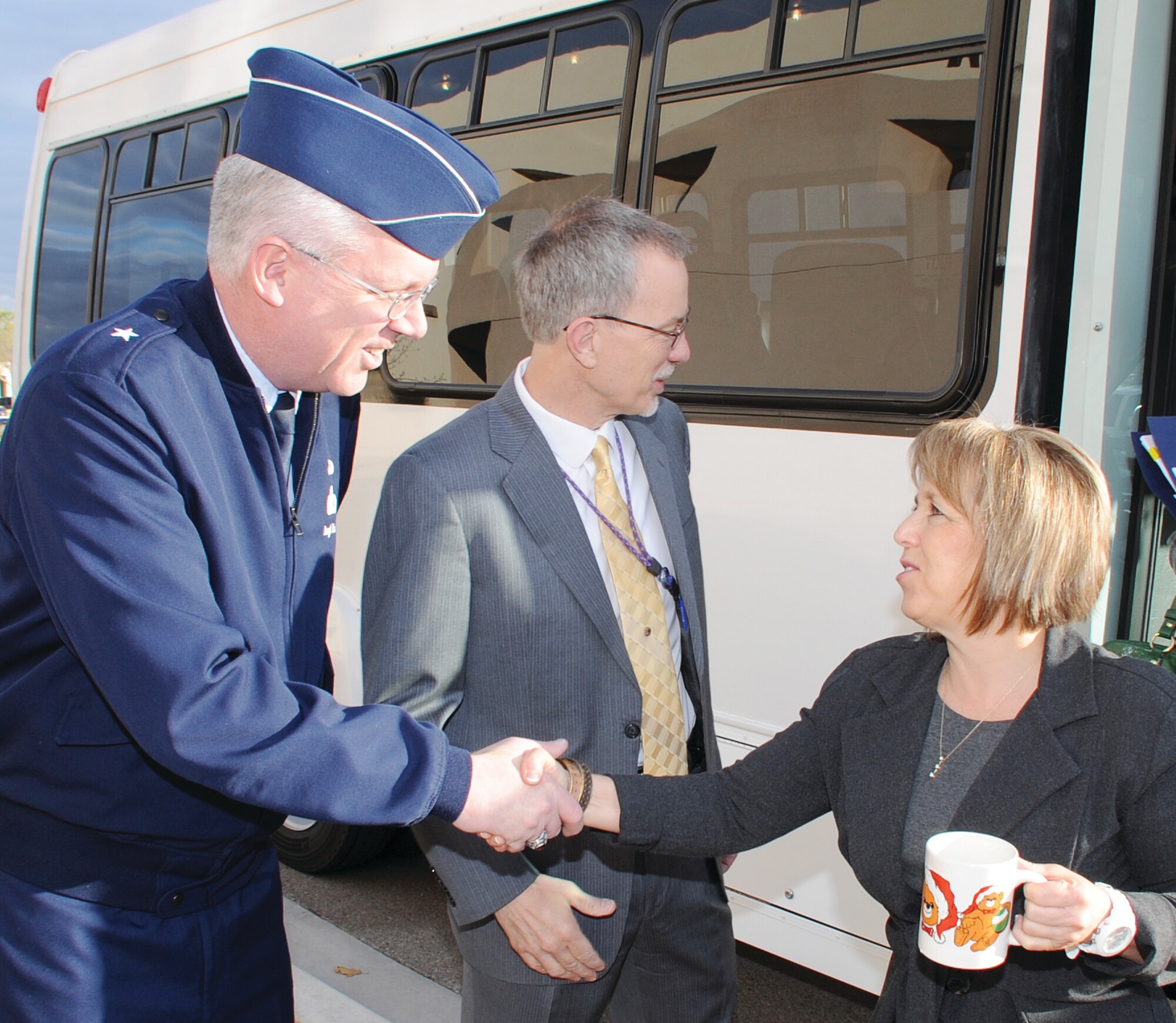 Brig. Gen. Daryl Hauck, Air Force program executive officer for strategic systems, left, and Dr. Wayne Brasure, Air Force Nuclear Weapons Center executive director, center, greet U.S. Rep. Michelle Lujan-Grisham during her April 3 arrival to Kirtland Air Force Base. (U.S. Air Force photo by Todd Berenger)