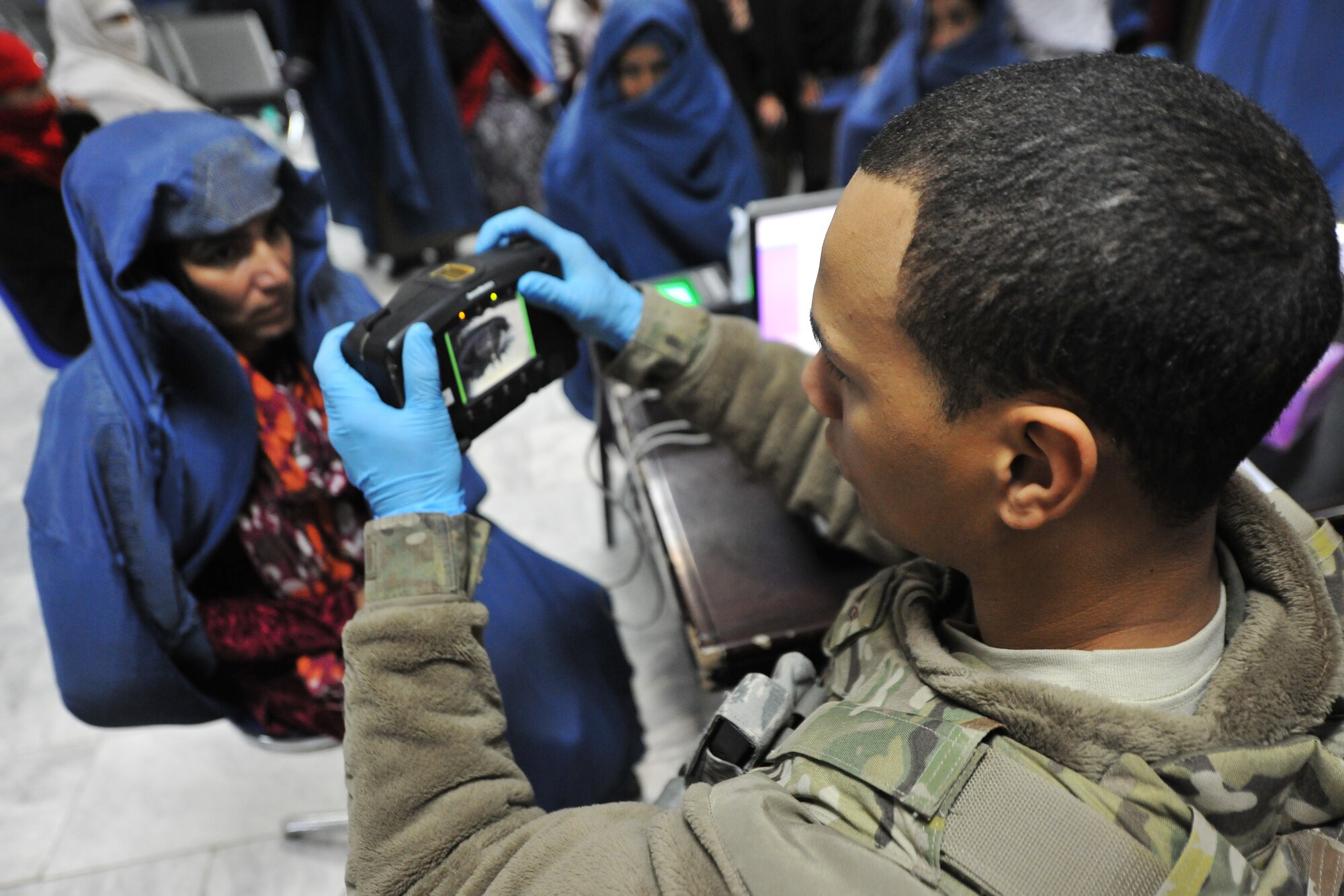 An Airman from the 455th Expeditionary Security Forces Group bravo sector collects biometric information from local Afghan wanting medical services at Bagram Airfield, Afghanistan, Dec. 2, 2012 Medical teams use biometrics to identify and track the records for all incoming patients by scanning their iris and fingerprints and then inputting the information into a database.  (U.S. Air Force photo/Senior Airman Chris Willis)