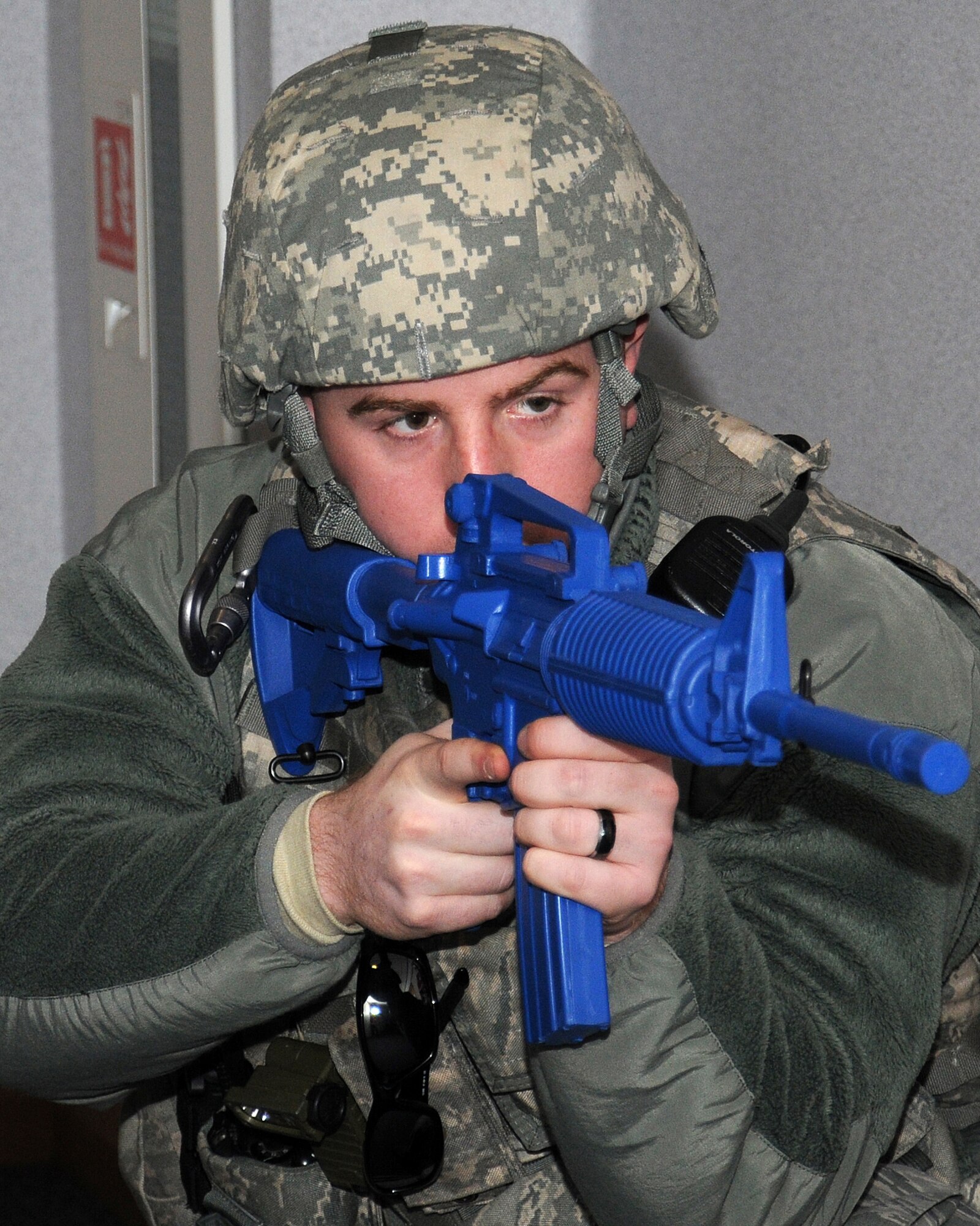 Staff Sgt. Daniel Montgomery, 100th Security Forces Squadron response force leader from Frankfort, Ohio, sweeps the area during an exercise March 28, 2013, at RAF Mildenhall, England. As part of an emergency lockdown exercise, an armed assailant was on RAF Mildenhall in the vicinity of building 809. Service members are trained how to react and deal with these kinds of scenarios. (U.S. Air Force photo by Gina Randall/Released)