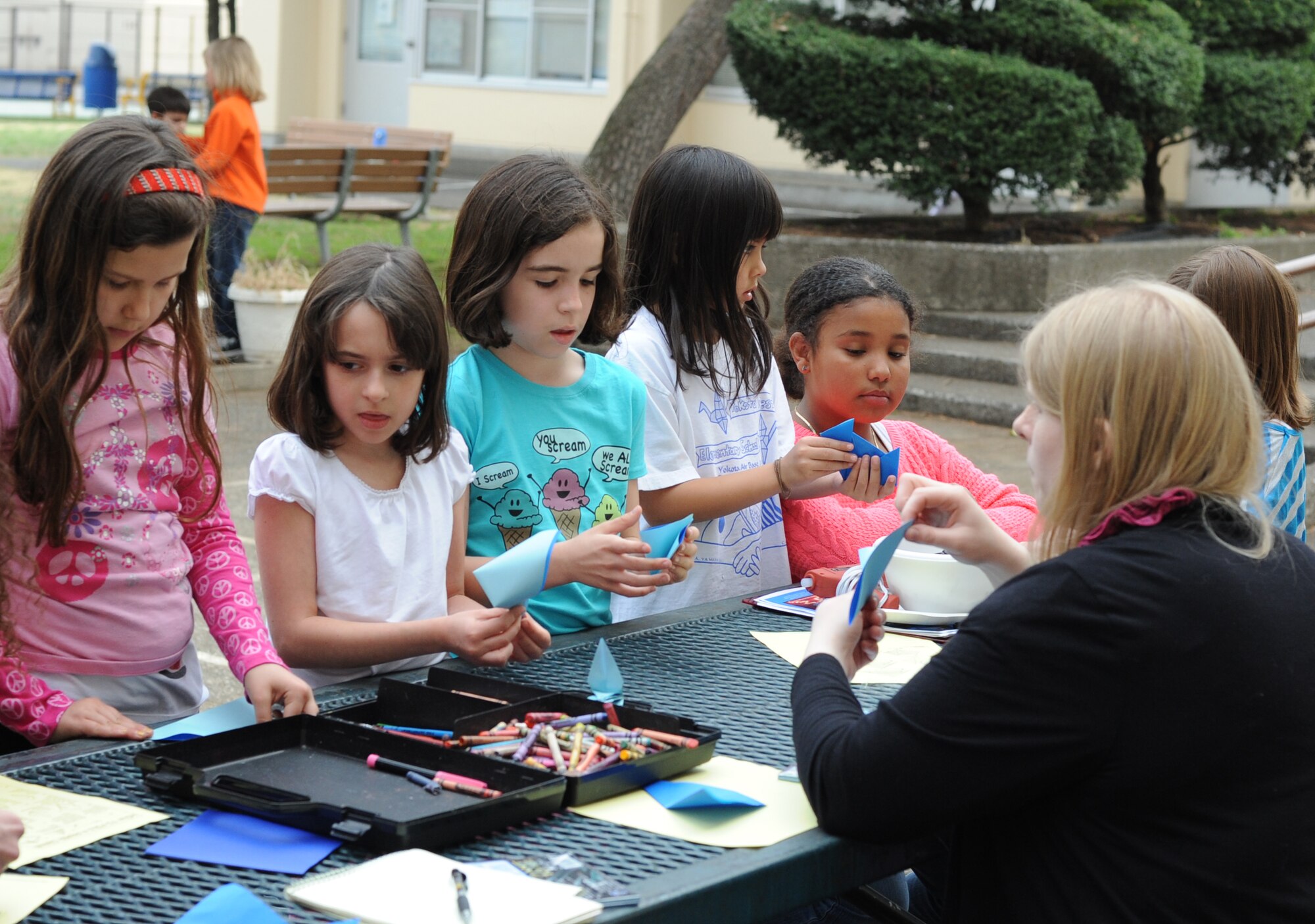 YOKOTA AIR BASE, Japan -- Students from Yokota Air Base, Japan, make origami figures during the Light It Up Blue event here April 2, 2013. Statues, buildings and historical monuments were lit up with blue light to raise awareness of autism. The origami figures were used to decorate the inside of the Yokota Community Center. (U.S. Air Force photo by Airman 1st Class Desiree Economides)