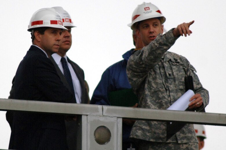 Lt. Col. James A. DeLapp (Right), U.S. Army Corps of Engineers Nashville District commander, points toward the Chickamauga Lock Addition Project's coffer dam from atop Chickamauga Dam during a tour of the project for Congressman Chuck Fleischmann (Left), representative of the 3rd District of Tennessee, and Congressman Bill Shuster, representative of the 9th District of Pennsylvania. Fleischmann invited Shuster, chairman of the Subcommittee on Railroads, Pipelines and Hazardous Materials of the House and Infrastructure Committee, to tour the construction site of a new lock that is currently not appropriated for completion. (USACE photo by Leon Roberts)