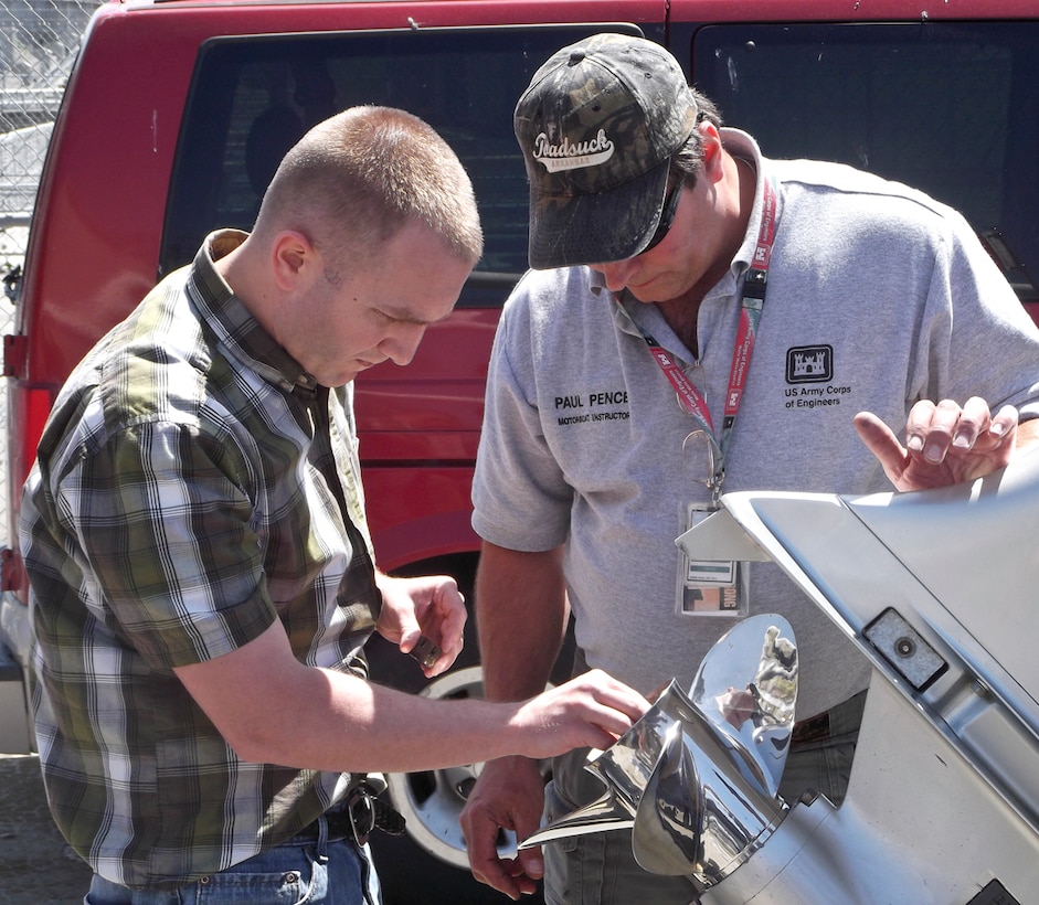 Walla Walla District motorboat instructor, Paul Pence, showing District Office civil engineer, Arron Schuff, how to properly change a boat propeller at the District Motorboat Licensing course.  All Corps of Engineers employees who operate USACE boats/vessels less than 26 feet in length are required to be trained, tested and licensed in accordance with recognized Federal, state and local laws and standards.
