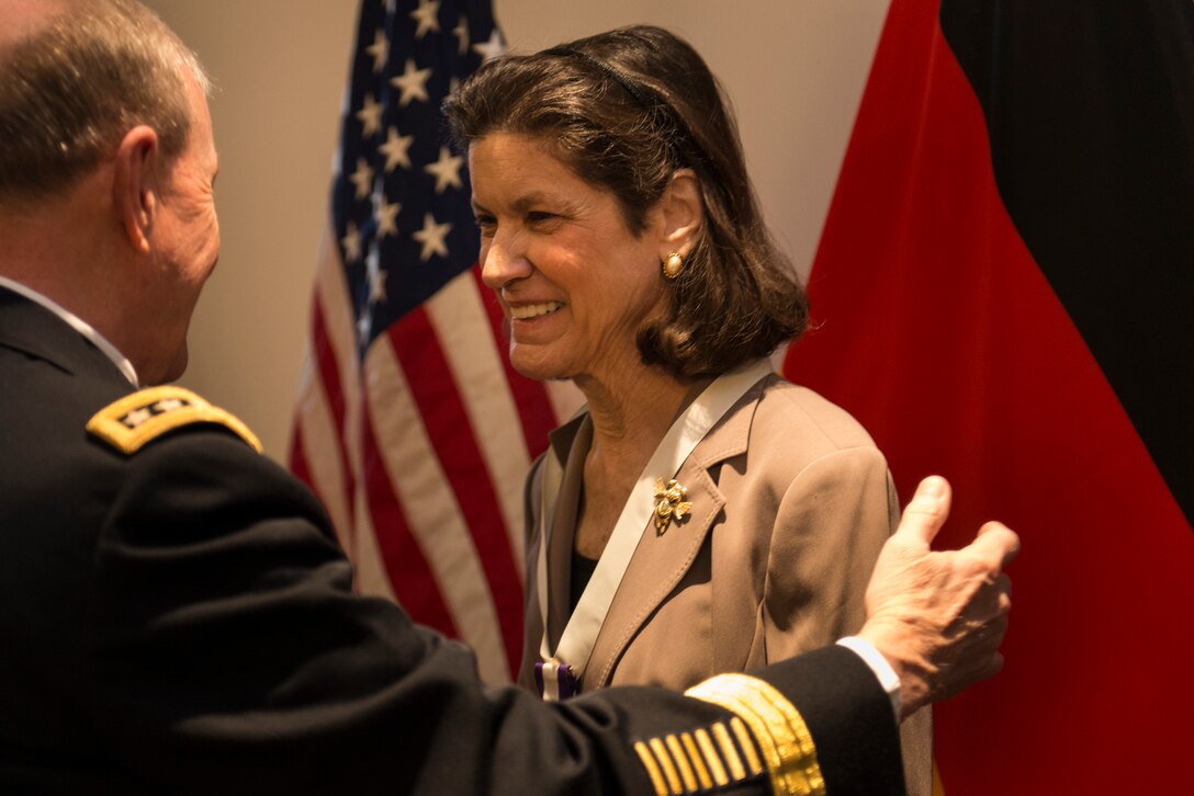 U.S. Army Gen. Martin E. Dempsey, chairman of the Joint Chiefs of Staff, talks with Christi Ham, wife of U.S. Army Gen. Carter F. Ham, before the U.S. Africa Command change-of-command ceremony in Stuttgart, Germany, April 5, 2013. Carter is the outgoing commander.