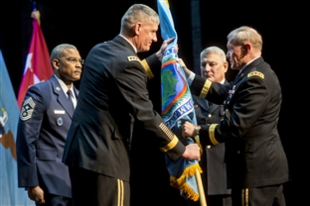 U.S. Army Gen. Martin E. Dempsey, right, chairman of the Joint Chiefs of Staff, U.S. Army Gen. Carter F. Ham, center, and U.S. Army Gen. David M. Rodriguez participate in a U.S. Africa Command ceremony during which Rodriquez assumed command from Ham in Stuttgart, Germany, April 5, 2013.