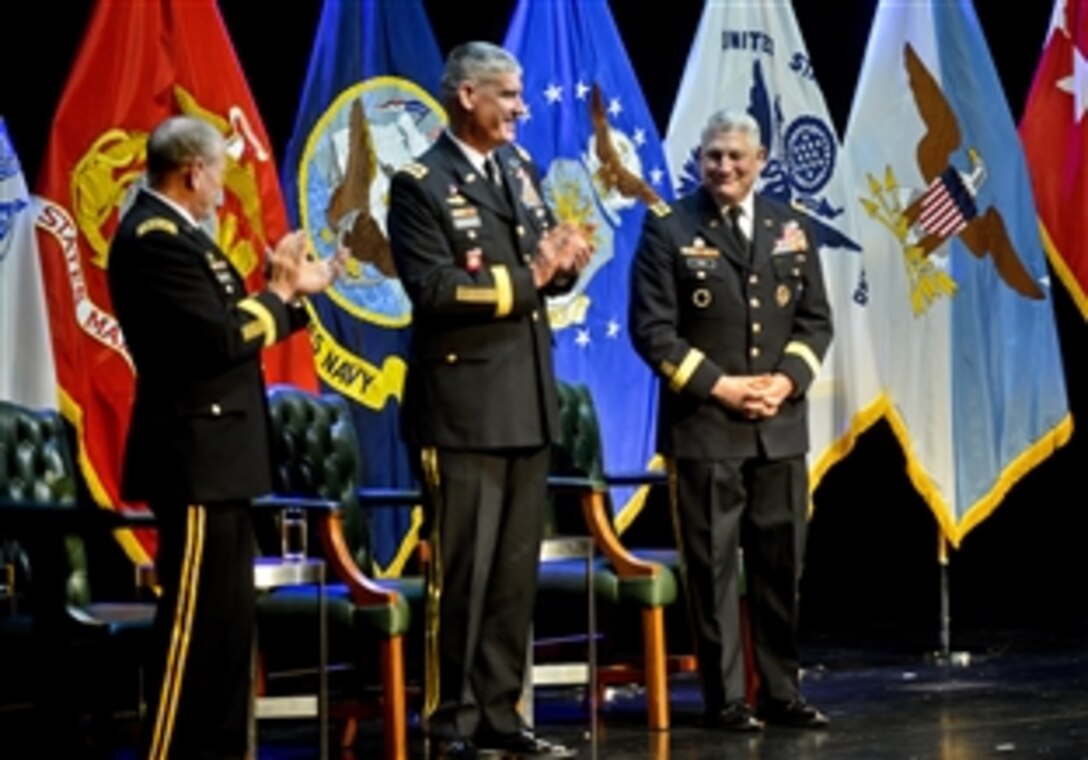 U.S. Army Gen. Martin E. Dempsey, chairman of the Joint Chiefs of Staff, left, and U.S. Army Gen. David M. Rodriguez, incoming commander of U.S. Africa Command, applaud U.S. Army Gen. Carter F. Ham, outgoing commander, during the change-of-ceremony in Stuttgart, Germany, April 5, 2013.