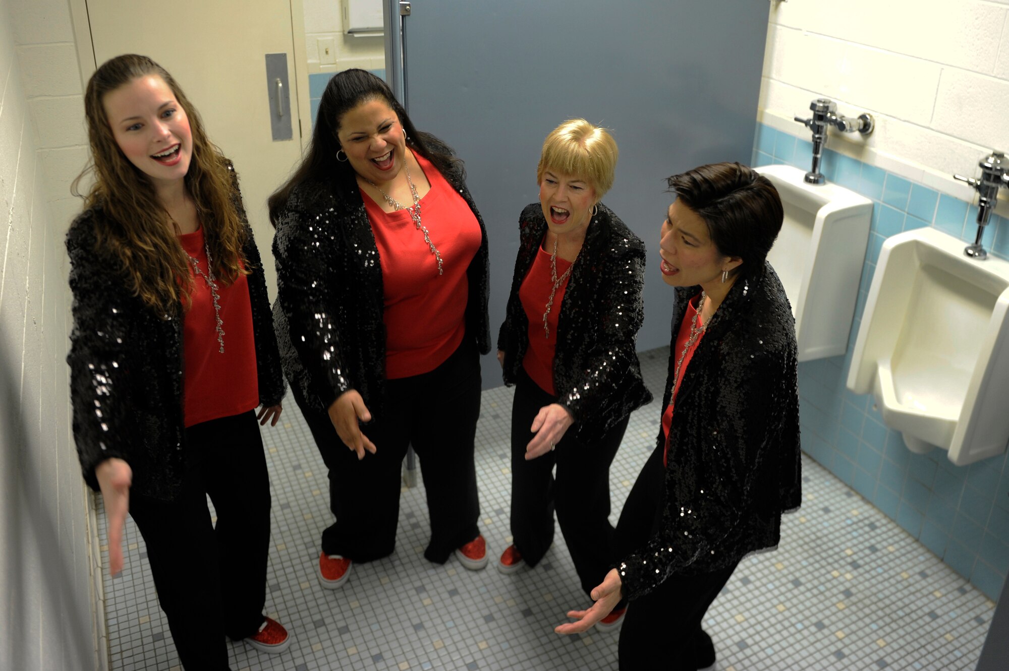 Col. Michelle Barrett (right) sings vocal warm-ups with The Excel Quartet of the Vienna-Falls Chorus of Fairfax, Va April 2, 2013. The quartet sings in the bathroom to take advantage of the great acoustics. The Excel quartet is the rookie quartet of the VF Chorus. (U.S. Air Force photo/Senior Airman Carlin Leslie)