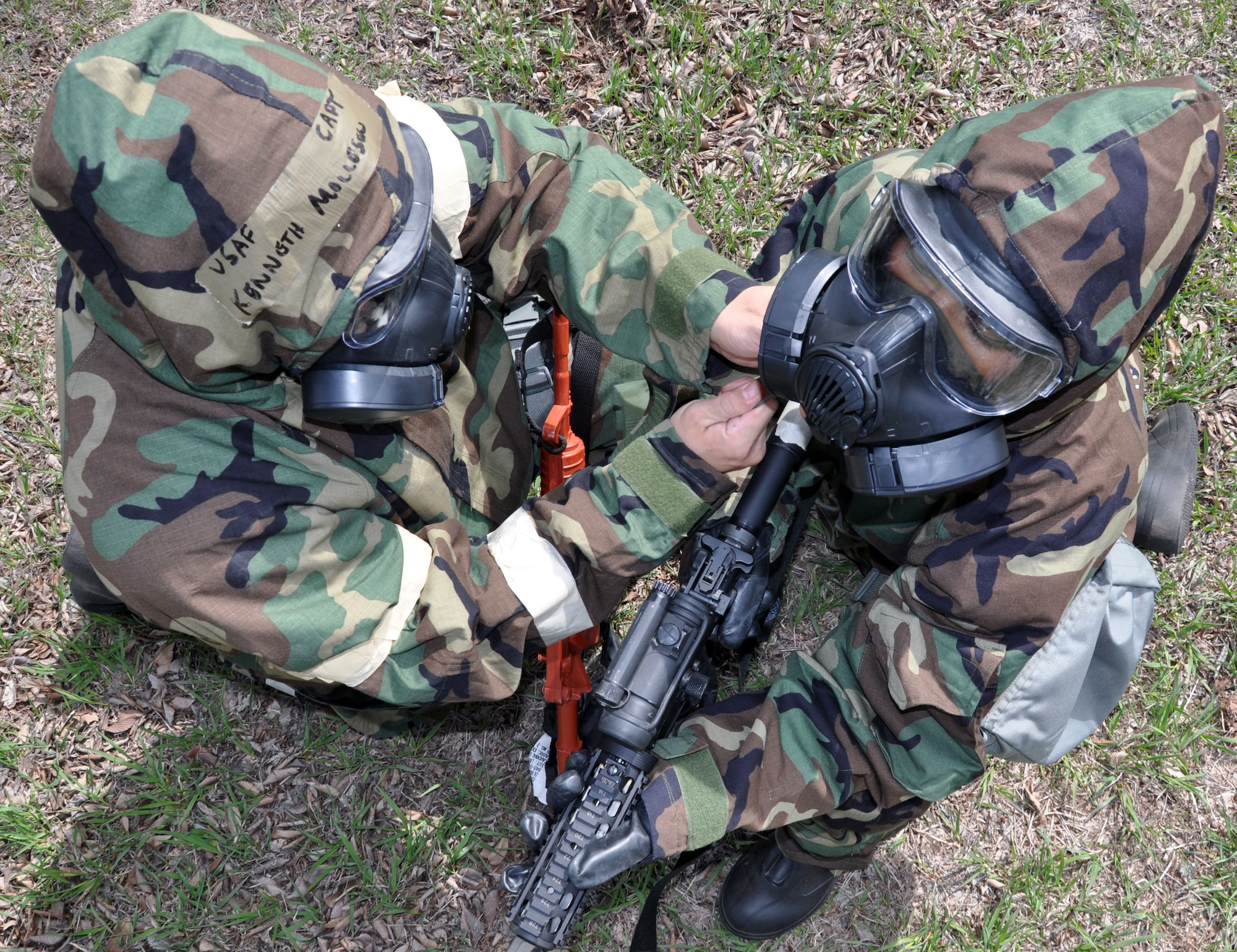 Members of the Air Force Reserve 931st Air Refueling Group Security Forces Squadron assist each other in donning Mission Oriented Protective Posture (MOPP) gear during a chemical warfare training excercise at McConnell Air Force Base, Kan., April 6, 2013.  The members of the 931 SFS practiced donning the gear in a combat situation and trained on building clearing procedures while wearing the equipment.  This training ensures the members of the 931 SFS can accomplish their military objectives under any conditions.  (U.S. Air Force photo by 1st Lt. Zach Anderson)