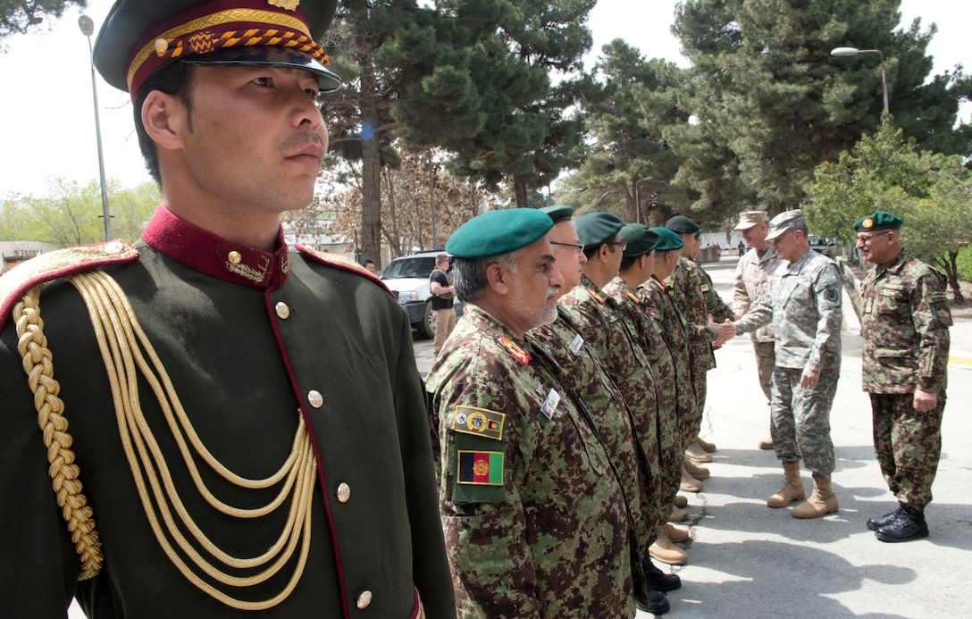Afghan army Gen. Sher Mohammad Karimi, right, chief of the Afghan army's general staff, introduces U.S. Army Gen. Martin E. Dempsey, chairman of the Joint Chiefs of Staff, to Afghan soldiers in Kabul, Afghanistan, Apr. 6, 2013. 