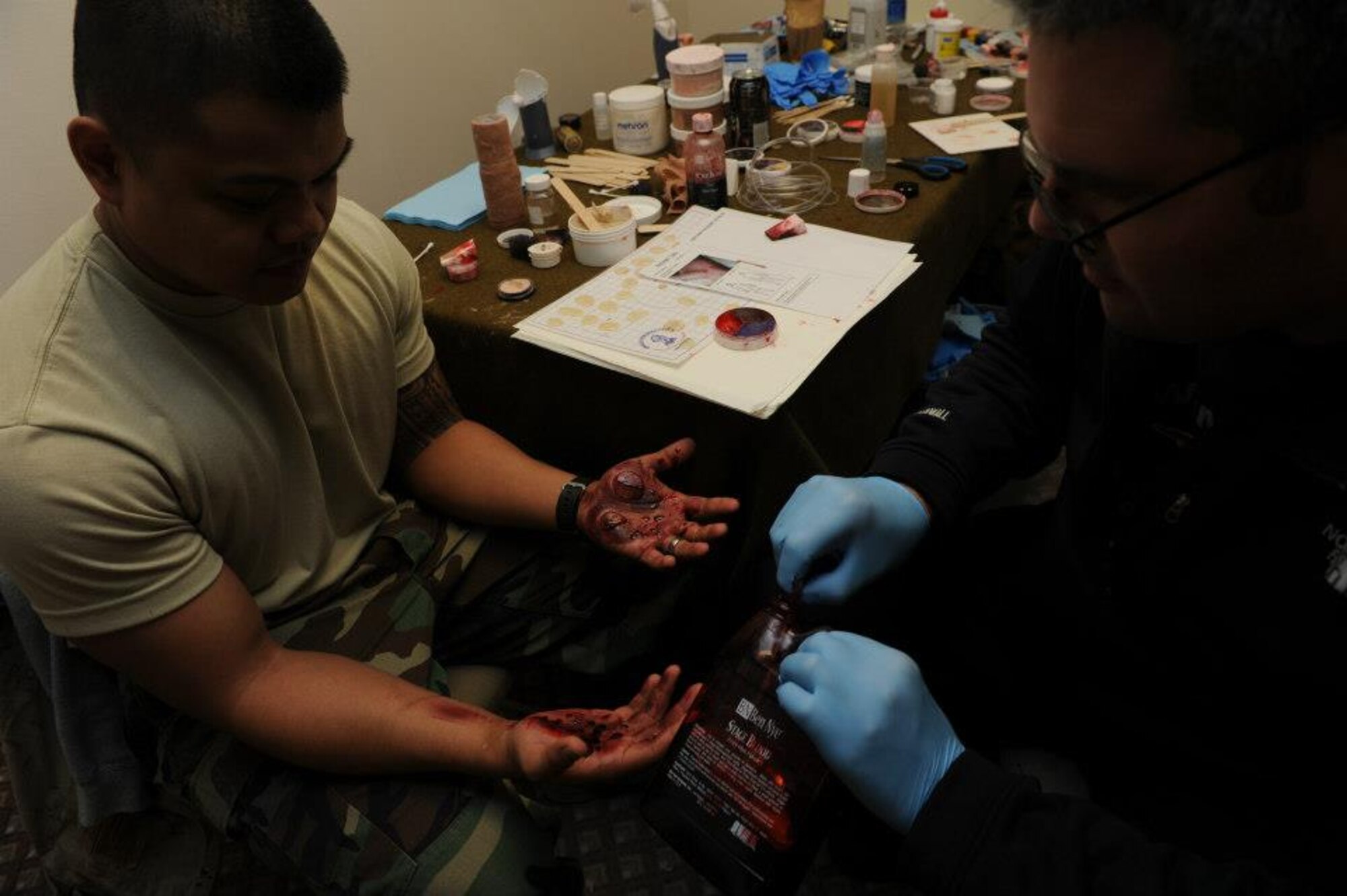 Master Sgt. Micheal Karl, a member of the 673d Medical Group, applies a moulage burn to the hands of Senior Airman Micheal Burket on JBER, April 7, 2013. Joint Base Elmendorf-Richardson Airmen are participating in exercise Polar Force 13-3 through April 8. (U.S. Air Force Photo/Airman 1st Class Omari Bernard)

