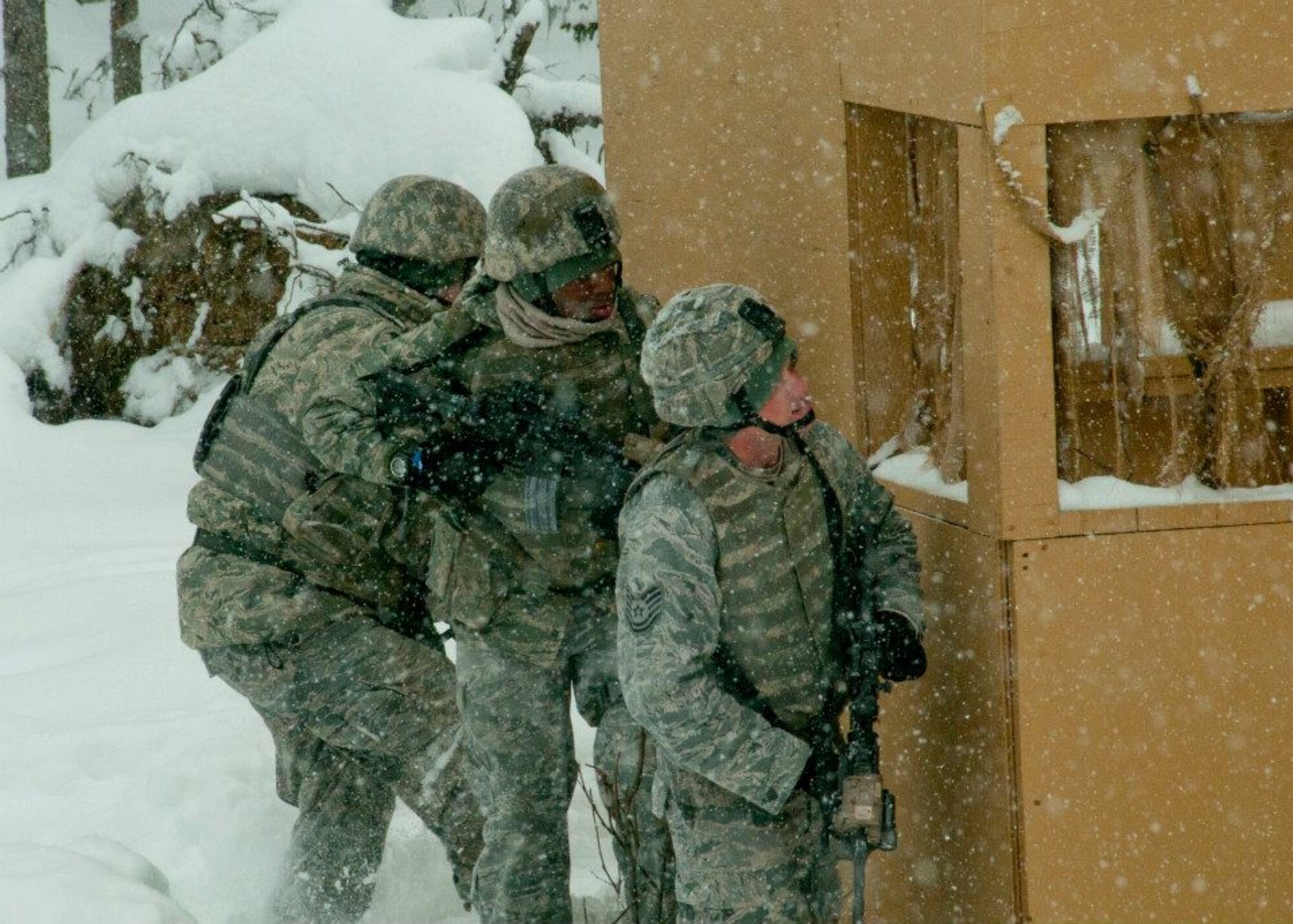 Members of the combined-forces security forces team practice urban warfare maneuvers at Joint Base Elmendorf-Richardson, Alaska, April 6. The readiness exercise is designed to validate the wing's ability to integrate, mobilize, and prepare assigned personnel, aircraft and equipment for their wartime mission and to employ forces and weapons systems to perform tasked missions. (National Guard photo/Staff Sgt. N. Alicia Goldberger) 