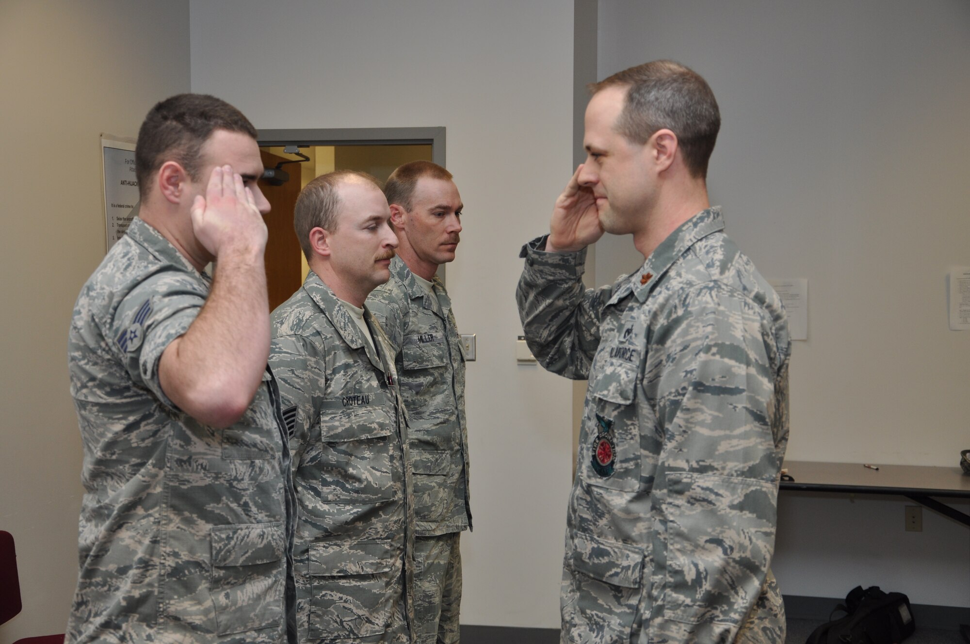 Senior Airman Zachariah Sierks, 442nd Civil Engineers Squadron fire fighter, salutes Maj. Ross McAfee, 442nd CES commander, during a commanders call after receiving a letter of appreciation, April 7, 2013. Sierks, Tech. Sgt. Matthew Croteau and Staff Sgt. Dustin Miller were presented with LOA’s for their actions when they saved a man's life. The 442nd CES is part of the 442nd Fighter Wing, an A-10 Thunderbolt II Air Force Reserve unit at Whiteman Air Force Base, Mo. (U.S. Air Force photo/Staff Sgt. Lauren Padden)