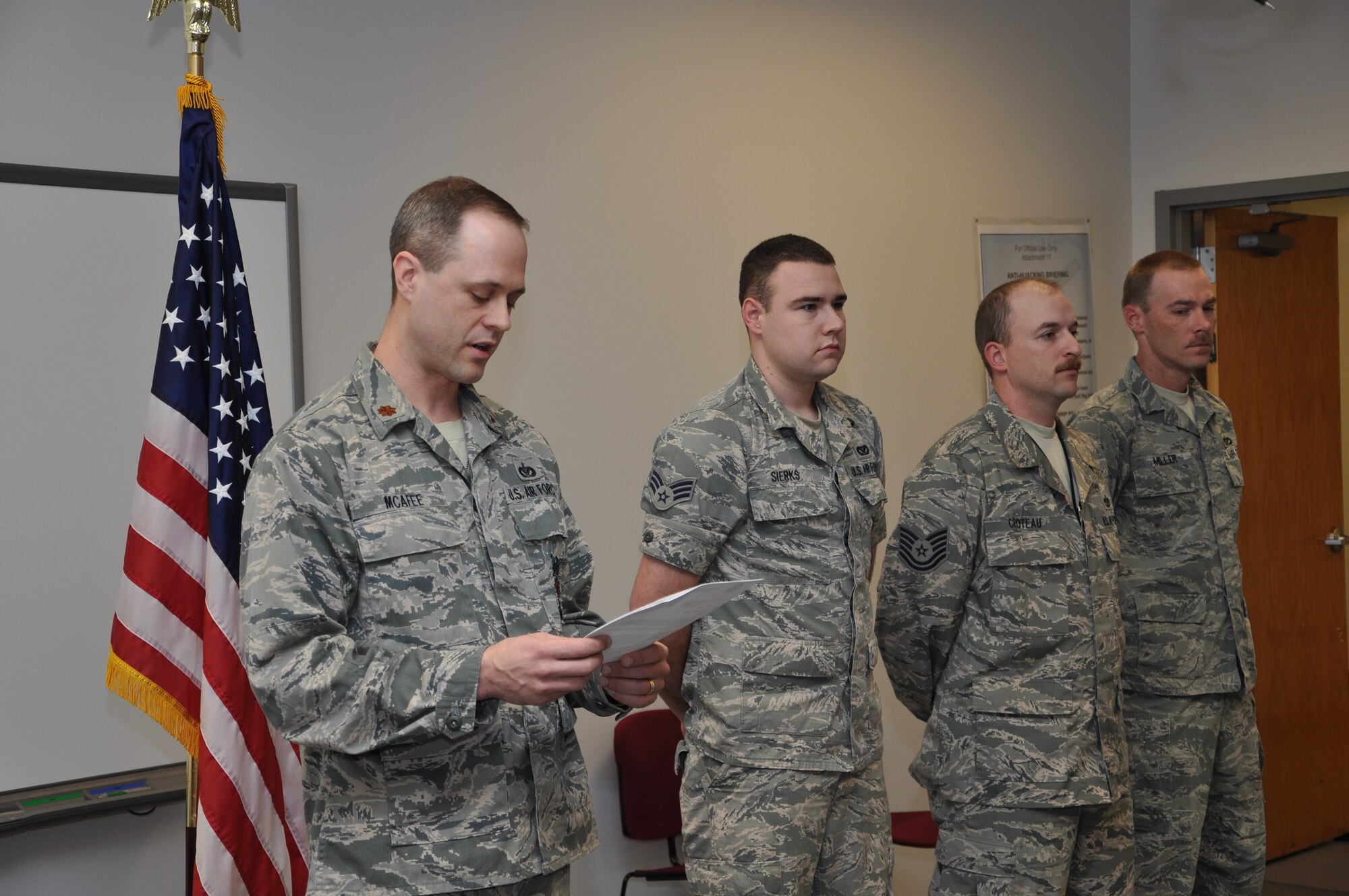 Maj. Ross McAfee, 442nd Civil Engineers Squadron commander reads a letter of appreciation, recognizing the actions of Senior Airman Zachariah Sierks, Tech. Sgt. Matthew Croteau and Staff Sgt. Dustin Miller, 442nd Civil Engineering Squadron fire fighters during a commander’s call, April 7, 2013. Their swift actions saved a man's life. The 442nd CES is part of the 442nd Fighter Wing, an A-10 Thunderbolt II Air Force Reserve unit at Whiteman Air Force Base, Mo. (U.S. Air Force photo/Staff Sgt. Lauren Padden)
