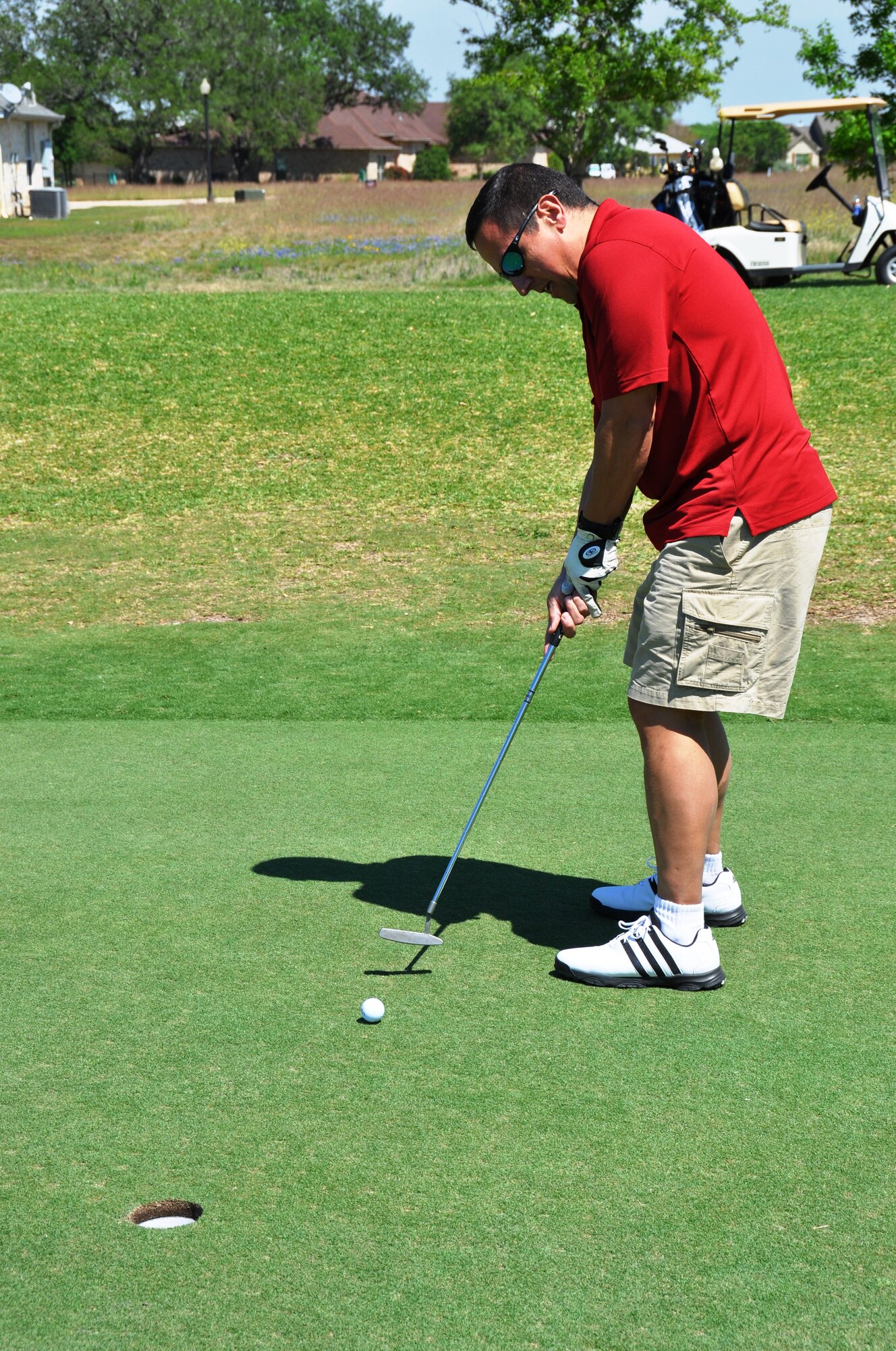 Col. Anthony Pena, 433rd Medical Squadron commander, putts during the Inaugural MXG Golf Tournament at the Alsatian Golf Club in Castroville, Texas on April 5.  The tournament had over 120 players participate to support the wing's care and share fund for deployed members' families. (U.S. Air Force photo/Tech Sgt. Carlos J. Trevino)