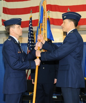 New York Air National Guard Col. Michael Comella (right), incoming commander of the 152nd Air Operations Group, accepts the guidon from Col. Greg Semmel,174th Attack Wing Commander, during a Change of Command Ceremony held at Hancock Field Air National Guard Base, Syacuse, New York on April 6, 2013. (New York Air National Guard photo by Tech. Sgt. Justin A. Huett/Released)
