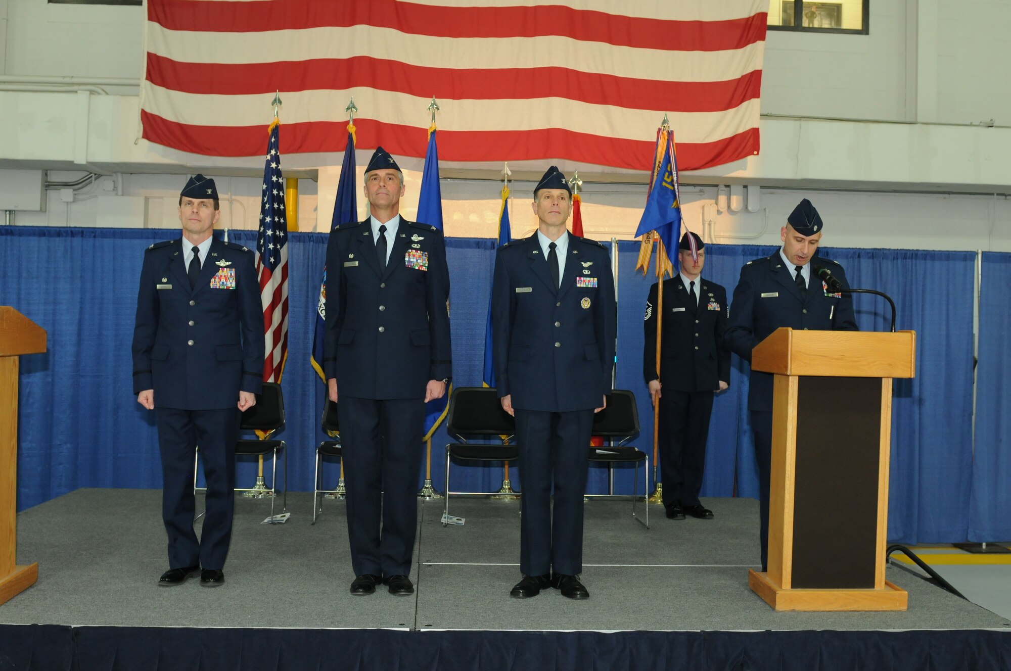 New York Air National Guard Col. Greg Semmel (left), Commander of the 174th Attack Wing, officiates the 152nd Air Operations Group's Change of Command ceremony held at Hancock Field Air National Guard Base, Syracuse, New York on 6 April, 2013.  During the ceremony, Col. Mark Murphy (second from left) turned over command to Col. Michael Comella. (New York Air National Guard photo by Tech. Sgt. Justin A., Huett/Released)

