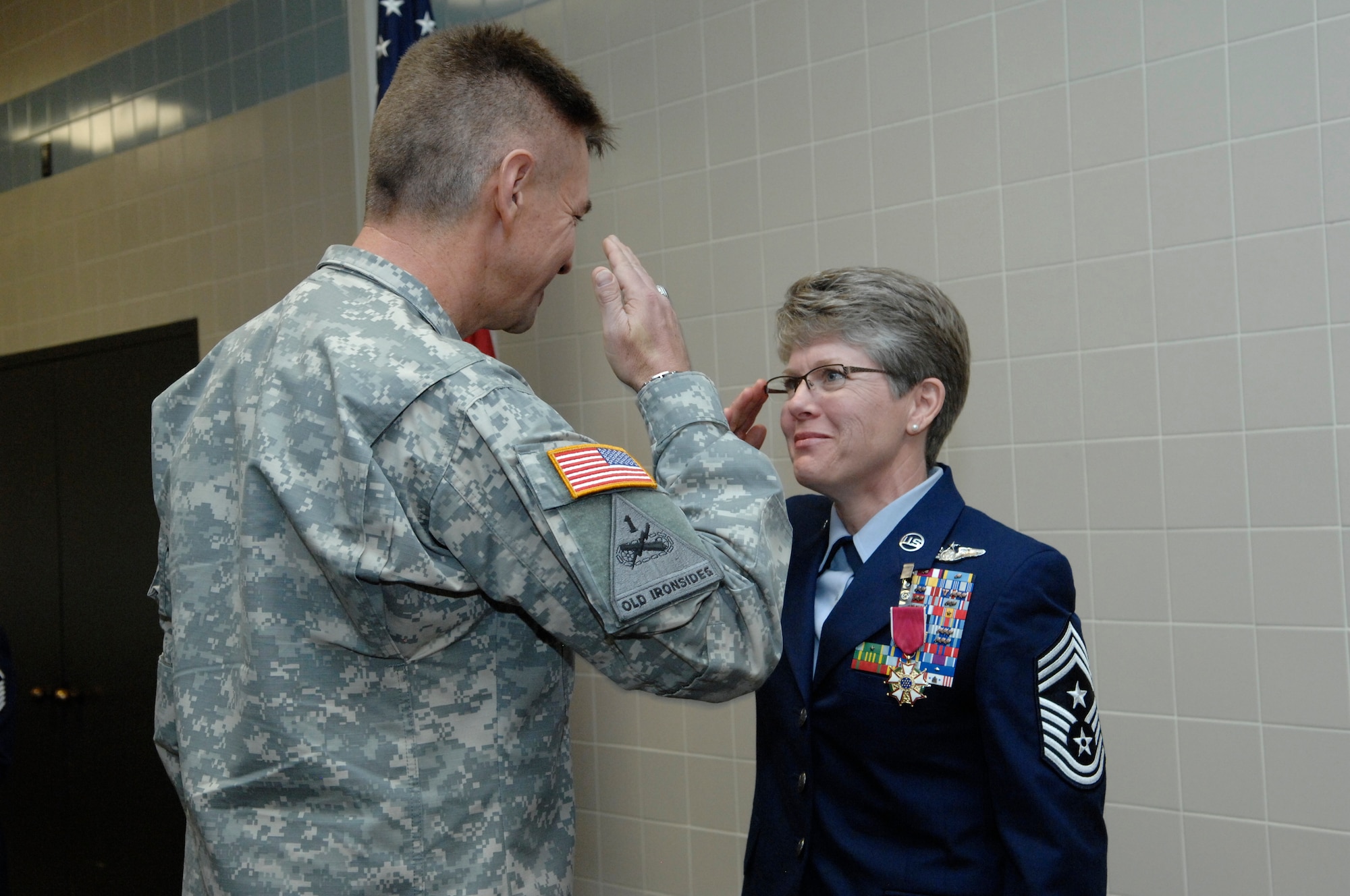 The Adjutant General of the Utah National Guard, Maj. Gen. Jefferson S. Burton, and State Command Chief Master Sergeant Denise Rager exchanged salutes during Rager's retirement ceremony at the Utah Air National Guard base, April 6, 2013. After 27 years of dedicated military service, Rager formally retired as the top enlisted service member in the Utah Air Guard. (U.S. Air Force photo by Senior Master Sgt. Gary Rihn)(RELEASED) 