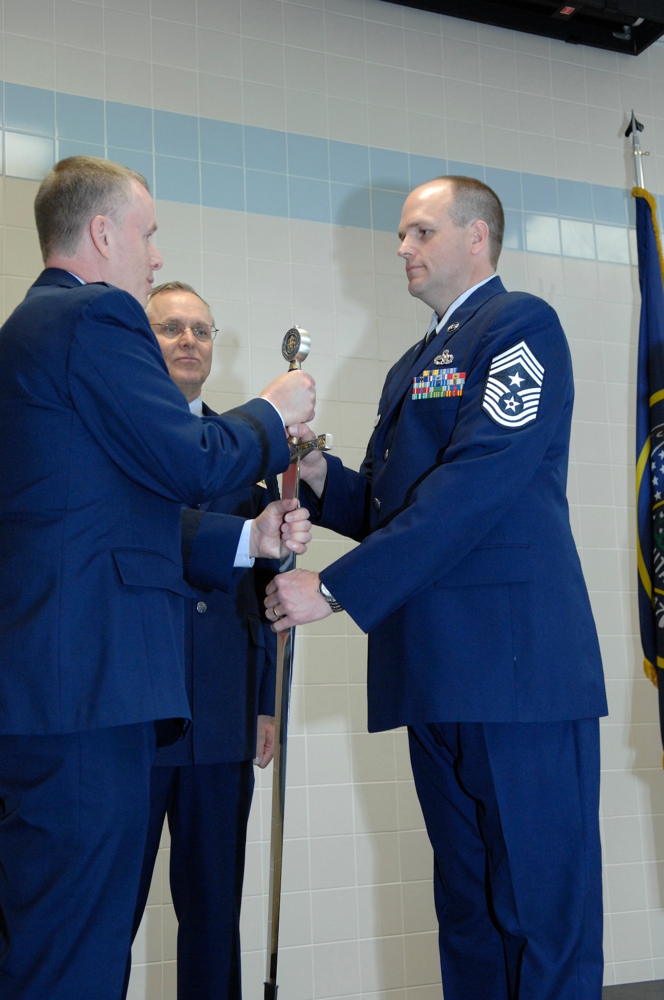 Chief Master Sgt. Michael Edwards accepted the sword from the Director of the Utah National Guard's Joint Staff, Brig. Gen. Kenneth L. Gammon, and assumed position as the new State Command Chief of the Utah Air National Guard during a ceremony at the Utah ANG base, April 6. In the passing-of-the-sword ceremony, the sword represents the duties and responsibilities of the State Command Chief Position. Edwards was formerly the State Human Resources Advisor and assumed position from State Command Chief Master Sergeant Denise Rager, who formally retired immediately after the passing-of-the-sword ceremony. Edwards is now the top enlisted service member in the Utah Air National Guard. (U.S. Air Force photo by Senior Master Sgt. Gary Rihn)(RELEASED) 