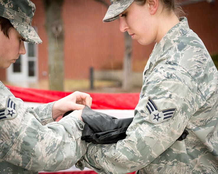 Senior Airmen Jacquelyn Kvilhaug and Devon Theis fold the POW/MIA flag during the retreat ceremony.  Airmen from the 934th Aeromedical Evacuation Squadron performed retreat on Saturday of the Unit Training Assembly weekend at the Minneapolis-St. Paul Air Reserve Station, Minn. (U.S. Air Force photo/Staff Sgt. Samantha Wagner)