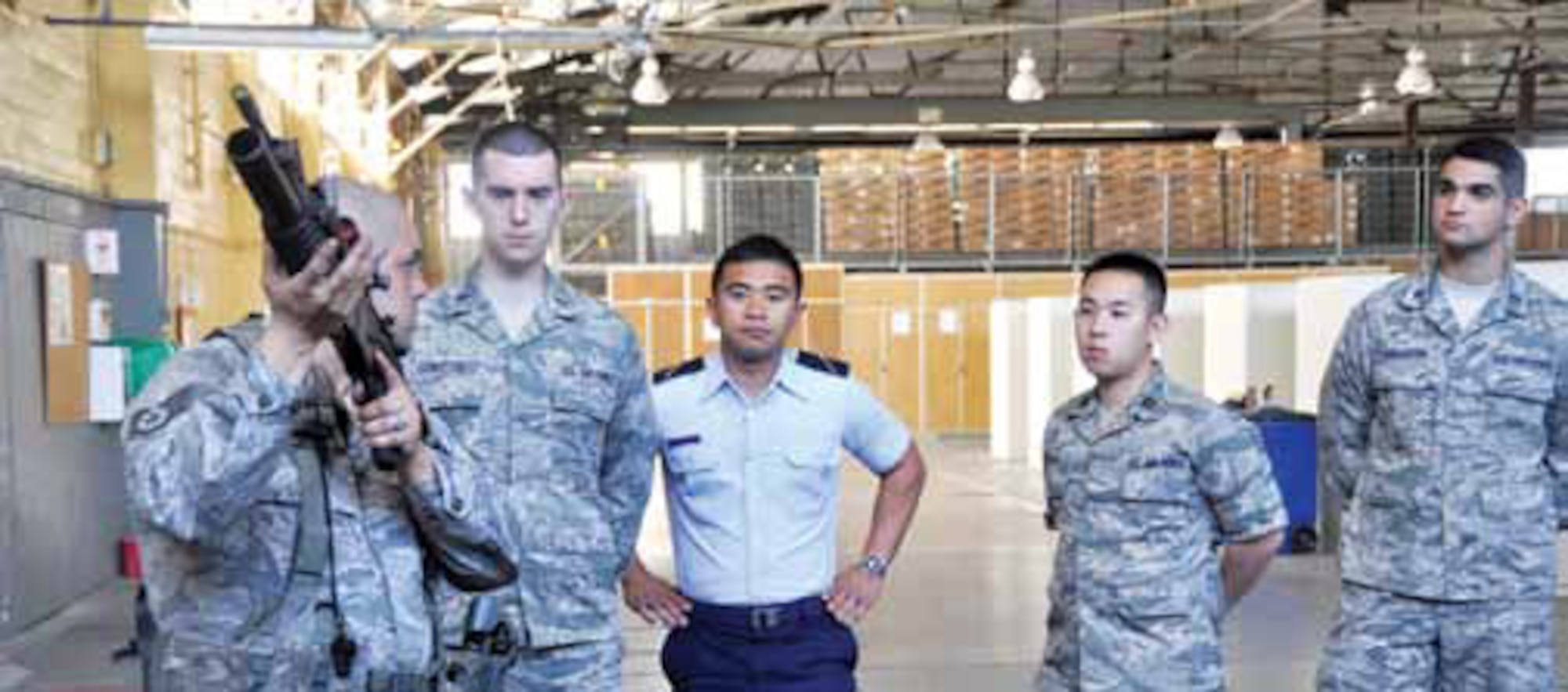 Fighting Fifty-fifth, University of California, Los Angeles, Air Force Reserve Officer Training Corps cadets receive a weapons demonstration from Staff Sgt. Anthony Patino, 452d Security Forces Squadron, March 28. (U.S. Air Force photo by Darnell Gardner)