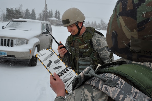 Staff Sgt. Robert Collier, 477th FG and Senior Airman Danielle Selisker 477th FSS, conduct a Post Attack Reconnisance sweep around the 477th FG headquarters during Polar Force 13-3. The 477th FG along with the National Guard 176th Wing and the active duty 3rd Wing and 673rd Air Base Wing particpated in the operational readiness exercise designed to test the unit's ability to deploy April 5-8. (U.S. Air Force Reserve photo/Tech. Sgt. Dana Rosso) 