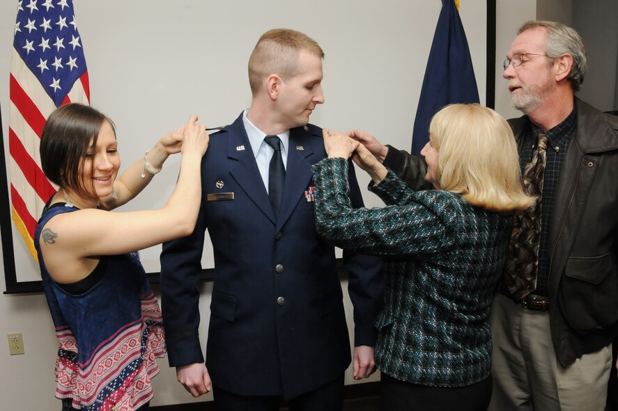 Maj. Scott Treadwell gets his Major rank pinned on by his wife, Allison (left) and his parents, Karl and Helen, during his promotion ceremony, Pease Air National Guard Base, N.H., April 6, 2013.  Treadwell is the commander of the 157th Comptroller Flight at Pease.  (U.S. Air National Guard photo by Staff Sgt. Curtis J. Lenz/RELEASED)
