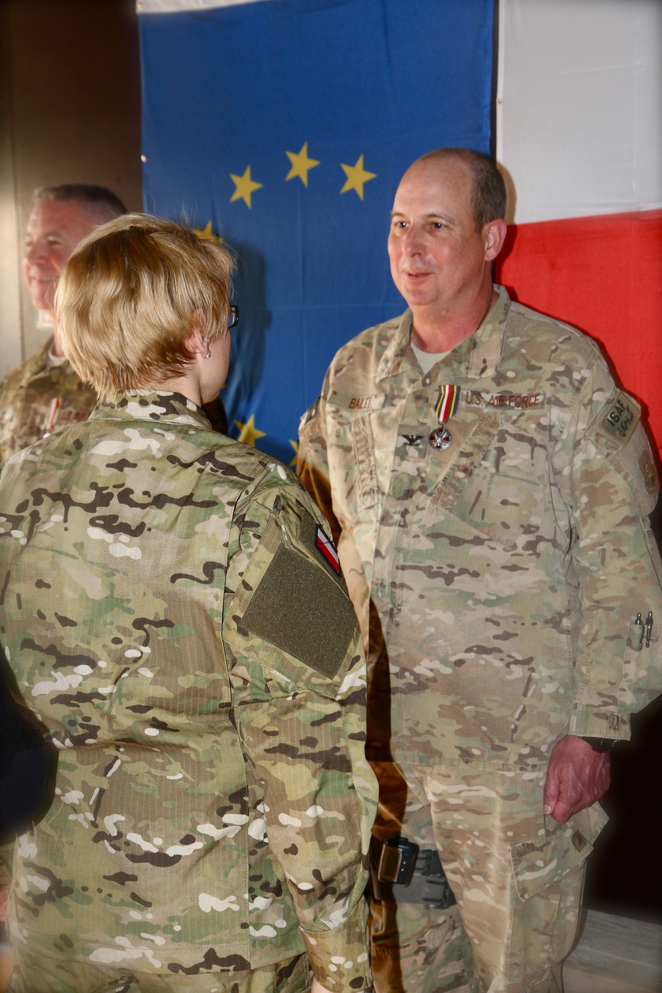Beata Oczkowicz, the Polish Deputy Minister of National Defense, presents the Polish Army Medal (Silver) to U.S. Air Force Col. Jimmie D. Bailey II, 455th Expeditionary Medical Group commander, at the Craig Joint Theater Hospital on Bagram Airfield, Afghanistan, March 27, 2013. Bailey accepted the medal on behalf of all of the men and women of Craig Joint Theater Hospital for their support to wounded Polish servicemembers. The Polish Army Medal was established in 1999 to recognize foreign nationals, military or civilian, for their service to the Polish Armed Forces. Bailey said "this has been one of the most memorable events of my year here.  It has been an honor to serve with our Coalition partners." (U.S. Air Force photo courtesy of Maj. Tara Pierce)