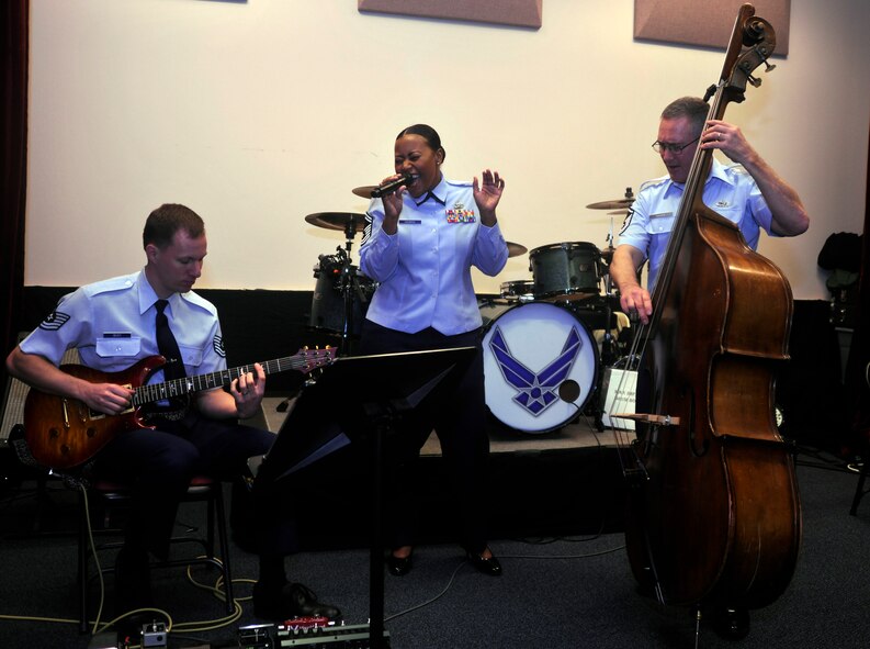 Before another day of meetings, emails and memos, (from left to right) Tech. Sgt. Matthew Geist, Senior Master Sgt. Regina Coonrod and Master Sgt. David Fostertake ease into their day with an impromptu jam session  March 29, 2013, at Joint Base Anacostia-Bolling, Washington, D.C. , Giest, Coonrod and Fostertake are members of the U.S. Air Force Band. The mission of the band is to honor those who have served, inspire American citizens to heightened patriotism and service, and positively impact the global community on behalf of the U.S. Air Force and the United States of America. (U.S. Air Force photo/Senior Airman Lindsey A. Porter)