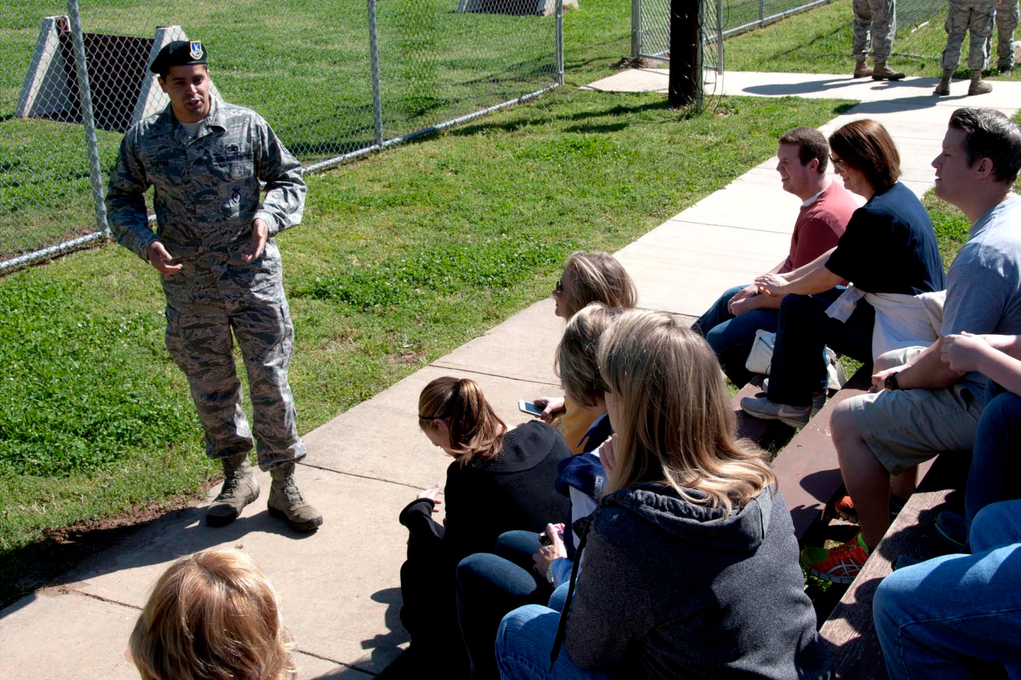 Students and chaperones from Trinity Christian School in Texarkana, Ark. listen attentively to a briefing by Staff Sgt. Erik Santos, a 2nd Security Forces Squadron dog handler at Barksdale Air Force Base, La., April 5, 2013.  Santos explained how the dog handlers train and work with canines in various situations. After the briefing, members of the 2nd SFS treated the students to a working demonstration in which the canines worked in simulated scenarios and ran through an obstacle course.  The students also visited the dog’s kennels and learned about the expert care provided them by the handlers. (U.S. Air Force photo by Tech. Sgt. Ted Daigle/Released)