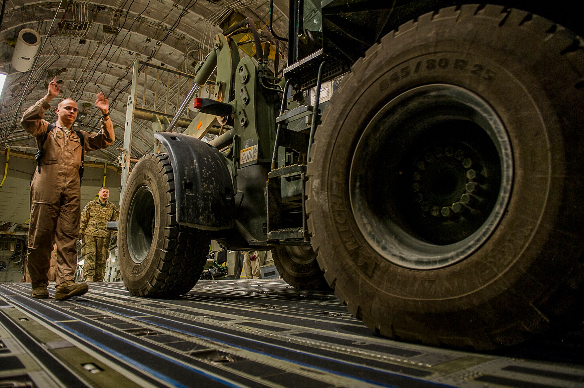 U.S. Air Force Senior Airman Blake Skidmore, 816th Expeditionary Airlift Squadron loadmaster, loads equipment on a C-17 Globemaster III for an airdrop over Afghanistan, March 30, 2013. The loadmaster performs calculations and plans cargo and passenger placement to keep aircraft within permissible center of gravity limits throughout flight. Loadmasters ensure cargo is placed on aircraft in such a way as to prevent overloading sensitive sections of the airframe and cargo floor. Skidmmore is deployed from the 15th Airlift Squadron at Joint Base Charleston, S.C. (U.S. Air Force photo/Tech. Sgt. Dennis J. Henry Jr.)