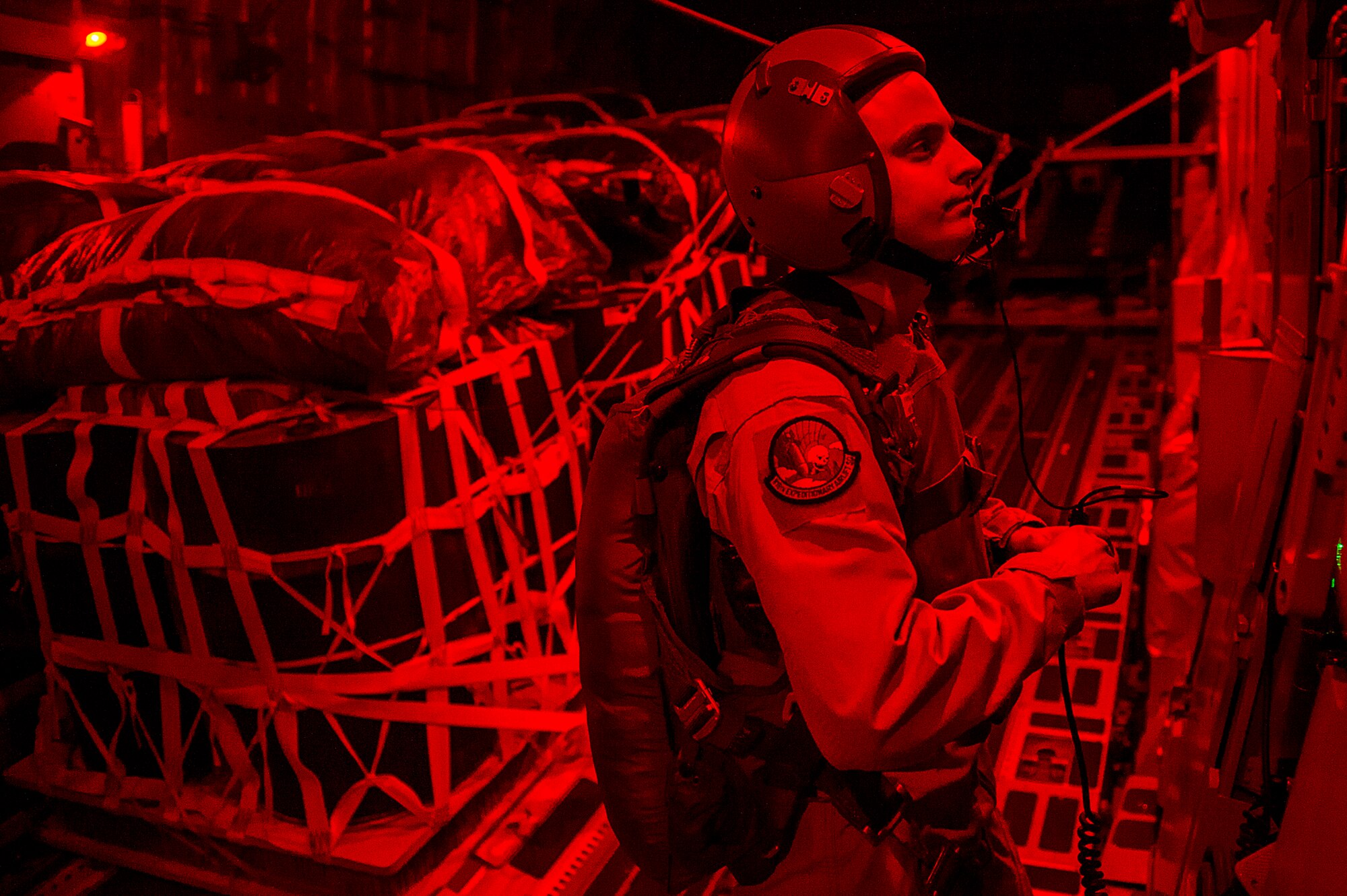 U.S. Air Force Senior Airman Blake Skidmore, 816th Expeditionary Airlift Squadron loadmaster, is ready to perform an airdrop mission over Afghanistan on a C-17 Globemaster III filled with bundles of supplies, March 30, 2013. The loadmaster performs calculations and plans cargo and passenger placement to keep aircraft within permissible center of gravity limits throughout flight. Loadmasters ensure cargo is placed on aircraft in such a way as to prevent overloading sensitive sections of the airframe and cargo floor. Skidmore is deployed from the 15th Airlift Squadron at Joint Base Charleston, S.C. (U.S. Air Force photo/Tech. Sgt. Dennis J. Henry Jr.)