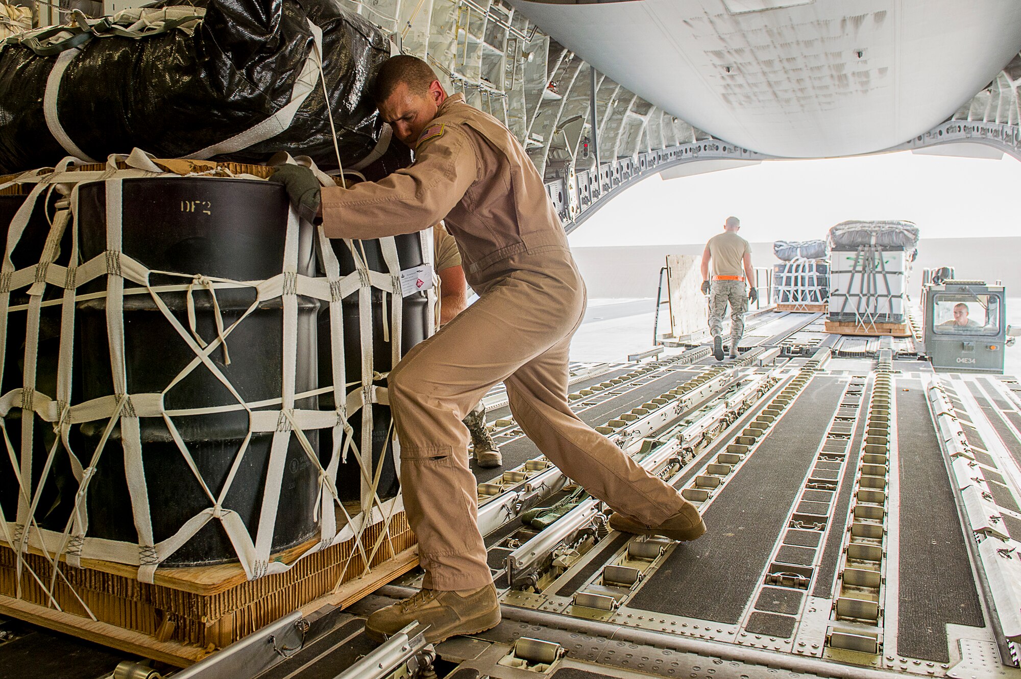 U.S. Air Force Staff Sgt. Travis Miller, 816th Expeditionary Airlift Squadron loadmaster, loads pallets of supplies into a C-17 Globemaster III for an airdrop over Afghanistan, March 30, 2013. The loadmaster performs calculations and plans cargo and passenger placement to keep aircraft within permissible center of gravity limits throughout flight. Loadmasters ensure cargo is placed on aircraft in such a way as to prevent overloading sensitive sections of the airframe and cargo floor. Miller is deployed from the 15th Airlift Squadron at Joint Base Charleston, S.C. (U.S. Air Force photo/Tech. Sgt. Dennis J. Henry Jr.)