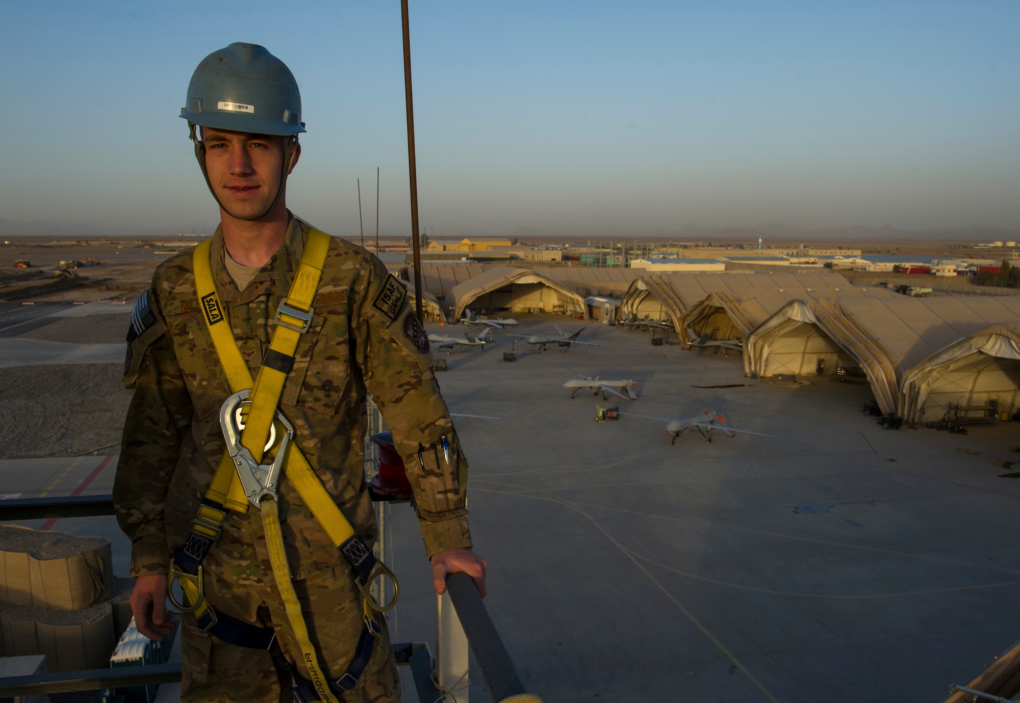 Airman 1st Class Alexander, 62nd Expeditionary Reconnaissance Squadron ground control station communications technician, stands on a ground data terminal tower, March 13, 2013, on Kandahar Airfield, Afghanistan. As a GCS communication technician, Alexander manages the communications in the cockpit that is used to fly remotely piloted aircraft. Alexander, a native of Grizzly Flats, Calif., is deployed from Creech Air Force Base, Nev. (U.S. Air Force photo by Staff Sgt. Marleah Miller)