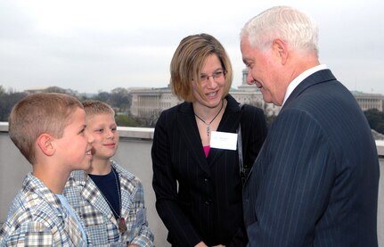 Defense Secretary Robert M. Gates talks with 10-year-old Will Bacon, right front, his brother, Jake, 9, and their mother, Christine, during an Our Military Kids reception in Washington, D.C., to honor military children April 7, 2008. The boys' father, Missouri National Guard Maj. Matt Bacon, is currently deployed to Iraq.