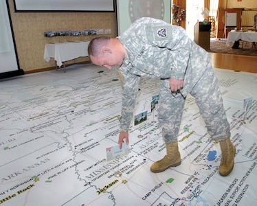 Maj. Steven Gilbert, ARNORTH G3, places markers on a map to indicate where units will respond in the hurricane preparedness drill that took place at Fort Belvoir's Community Center last week. The hurricane Rehearsal of Concept drill is held several times a year in various locations.