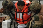 Soldiers help an injured role player during the Disaster Response Exercise. Soldiers were given different missions simultaneously to test the Louisiana National Guard's ability to respond to an emergency.
