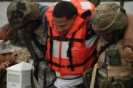 Soldiers help an injured role player during the Disaster Response Exercise. Soldiers were given different missions simultaneously to test the Louisiana National Guard's ability to respond to an emergency.