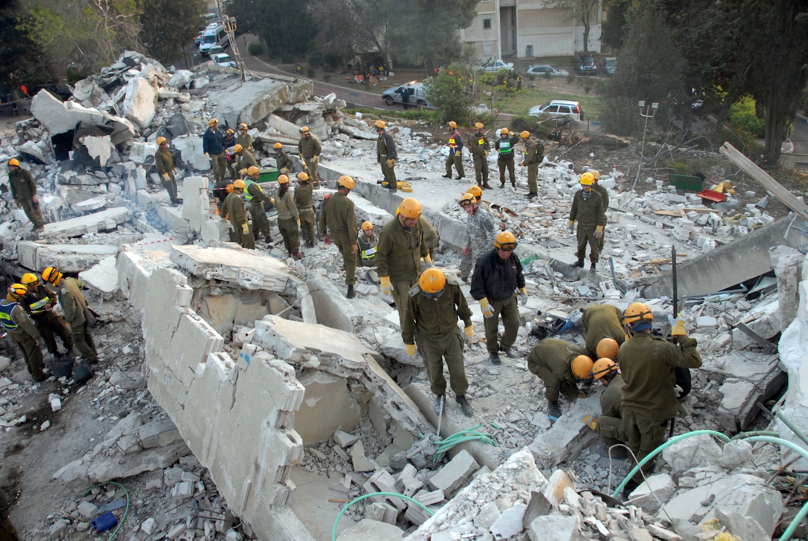 Members of the Israeli Defense Force's Homefront Command and civilian authorities search the rubble of a collapsed three-story building in Nazareth, Israel, on April 8, 2008, during Turning Point 2, a first-ever national level civil defense exercise. National Guard Bureau officials observed the exercise.