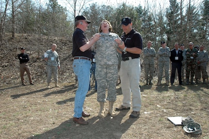 Arkansas Command Sgt. Maj. Deborah Collins reacts to her shocking encounter with a Taser X26 during a demonstration of nonlethal weapons for the National Guard Bureau's Senior Enlisted Leaders Conference in Saratoga Springs, N.Y., in April. "It was immediate, intense pain," she said.