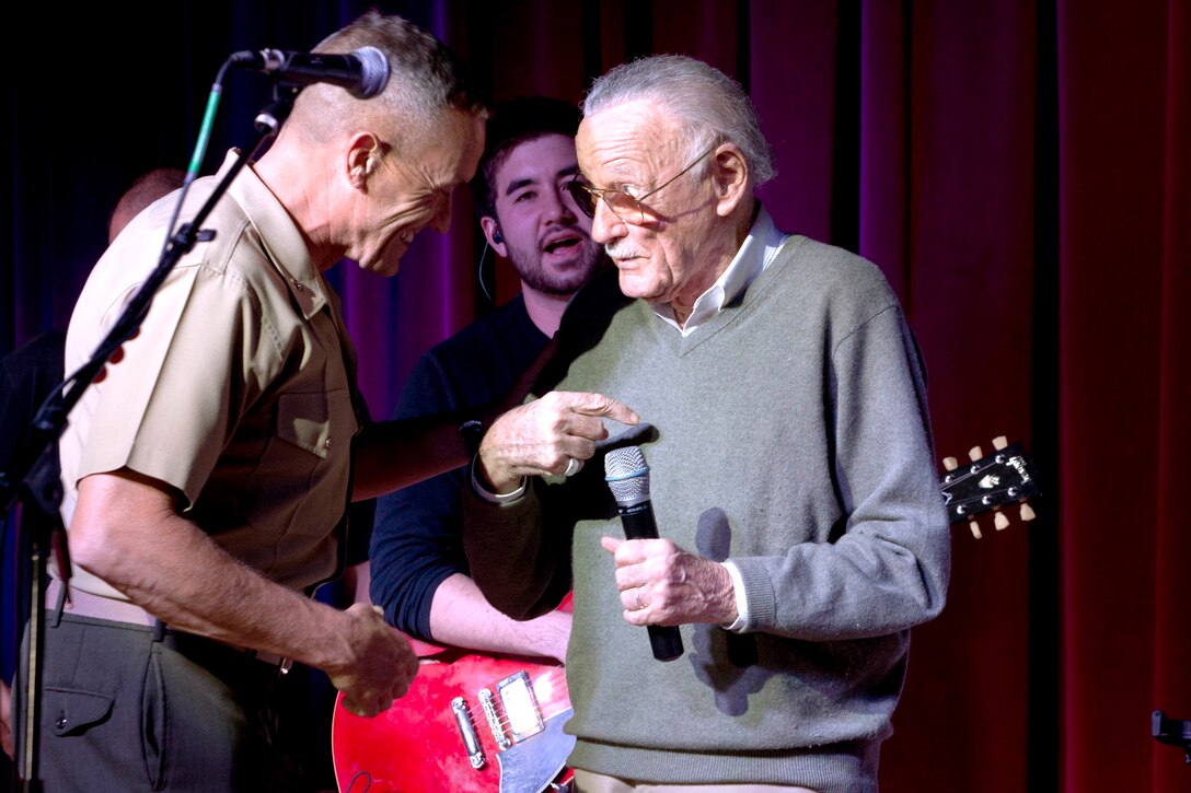 Brig. Gen. Vincent A. Coglianese, left, welcomes Stan Lee, right, to Pendleton during while giving opening remarks during Stan Lee's POW!er Concert at the Pacific Views Event Center here April 5. Coglianese is the base commanding general and regional authority for five military installations in the southwestern United States. Lee is the chairman and chief creative officer of POW! Entertainment.